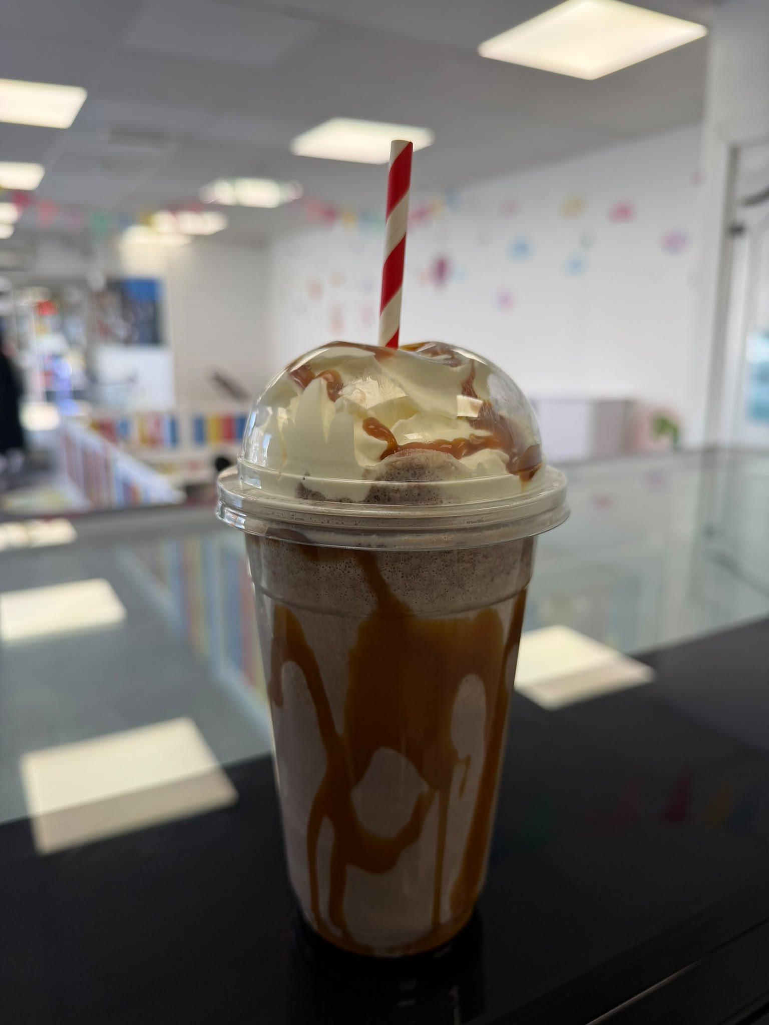 Caramel milkshake with whipped cream on the Fun Time counter