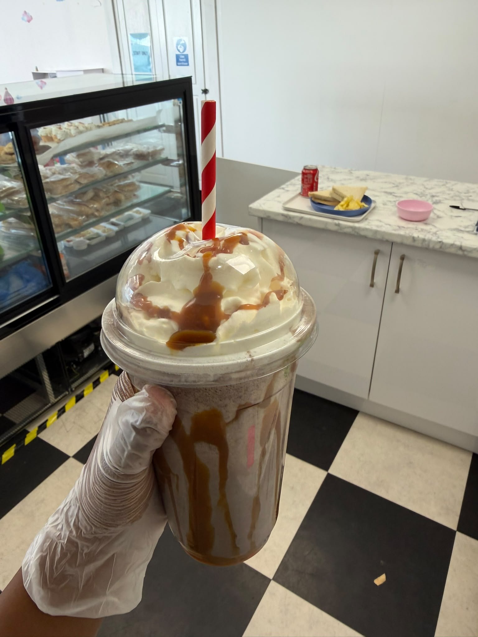 Milkshake with caramel drizzle and a striped straw